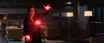 Movie still from “Captain America: Civil War” (2016), directed by Anthony Russo – A woman holding a red light in her hands; Medium shot, Over the shoulder angle