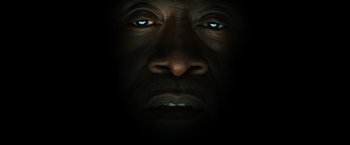 Movie still from “Captain America: Civil War” (2016), directed by Anthony Russo – A black man's face is lit up by the light of a candle; Extreme Close Up shot, Overhead angle
