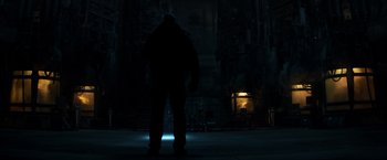 Movie still from “Captain America: Civil War” (2016), directed by Anthony Russo – A man standing in the dark with a light shining on him; Wide shot, Low angle