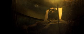 Movie still from “Captain America: Civil War” (2016), directed by Anthony Russo – A man sitting in front of a mirror in the dark; Medium shot, Low angle