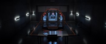 Movie still from “Captain America: Civil War” (2016), directed by Anthony Russo – A man sitting inside of a spaceship in a dark room; Wide shot, High angle