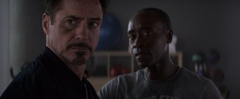 Movie still from “Captain America: Civil War” (2016), directed by Anthony Russo – Two men standing next to each other in a room; Close Up shot, Over the shoulder angle