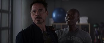 Movie still from “Captain America: Civil War” (2016), directed by Anthony Russo – Two men standing next to each other in a room; Close Up shot, Over the shoulder angle