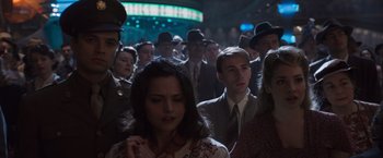 Movie still from “Captain America: The First Avenger” (2011), directed by Joe Johnston – A group of people in suits and hats standing in a crowd; Close Up shot, Over the shoulder angle