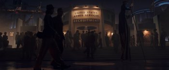 Movie still from “Captain America: The First Avenger” (2011), directed by Joe Johnston – A group of people walking on the sidewalk at night in front of a recruitment sign; Wide shot, Low angle