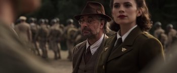 Movie still from “Captain America: The First Avenger” (2011), directed by Joe Johnston – A man and a woman wearing suits and hats; Close Up shot, Over the shoulder angle