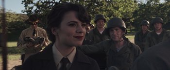 Movie still from “Captain America: The First Avenger” (2011), directed by Joe Johnston – A group of people standing next to each other in a field; Close Up shot, Over the shoulder angle