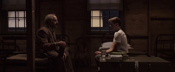 Movie still from “Captain America: The First Avenger” (2011), directed by Joe Johnston – Two men are sitting in a room talking; Medium shot, Over the shoulder angle