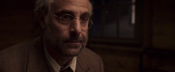 Movie still from “Captain America: The First Avenger” (2011), directed by Joe Johnston – An older man wearing glasses and a suit; Close Up shot, Over the shoulder angle