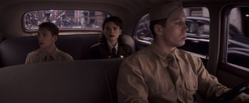 Movie still from “Captain America: The First Avenger” (2011), directed by Joe Johnston – A man and a woman sitting in the back of a car; Medium shot, Over the shoulder angle