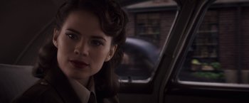 Movie still from “Captain America: The First Avenger” (2011), directed by Joe Johnston – A woman sitting in the back seat of a car; Close Up shot, Over the shoulder angle
