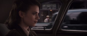 Movie still from “Captain America: The First Avenger” (2011), directed by Joe Johnston – A woman sitting in the back seat of a car looking out the window; Close Up shot, Over the shoulder angle
