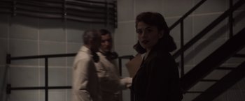 Movie still from “Captain America: The First Avenger” (2011), directed by Joe Johnston – A woman standing next to a man in a room; Medium shot, Over the shoulder angle