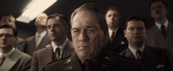 Movie still from “Captain America: The First Avenger” (2011), directed by Joe Johnston – A man in a military uniform with two other men in suits; Close Up shot, Low angle