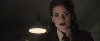 Movie still from “Captain America: The First Avenger” (2011), directed by Joe Johnston – A person wearing a suit and tie; Close Up shot, Over the shoulder angle