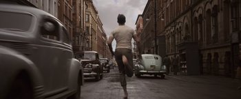 Movie still from “Captain America: The First Avenger” (2011), directed by Joe Johnston – A man running down the middle of a street; Wide shot, High angle