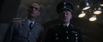 Movie still from “Captain America: The First Avenger” (2011), directed by Joe Johnston – Two men in military uniforms standing next to each other; Medium shot, Low angle