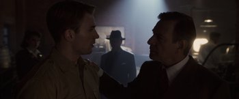 Movie still from “Captain America: The First Avenger” (2011), directed by Joe Johnston – Two men in suits and a man in a hat; Close Up shot, Over the shoulder angle