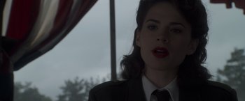 Movie still from “Captain America: The First Avenger” (2011), directed by Joe Johnston – A person wearing a suit and tie; Close Up shot, Over the shoulder angle