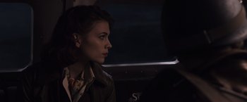 Movie still from “Captain America: The First Avenger” (2011), directed by Joe Johnston – A woman sitting in a car at night looking off into the distance; Close Up shot, Over the shoulder angle