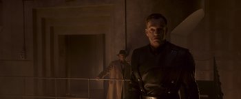 Movie still from “Captain America: The First Avenger” (2011), directed by Joe Johnston – A man in a trench coat standing next to another man in a leather jacket; Medium shot, Low angle
