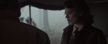 Movie still from “Captain America: The First Avenger” (2011), directed by Joe Johnston – A woman in a brown jacket standing next to another woman; Close Up shot, Over the shoulder angle