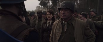 Movie still from “Captain America: The First Avenger” (2011), directed by Joe Johnston – A group of people in military uniforms standing next to each other; Medium shot, Over the shoulder angle