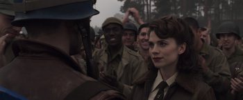 Movie still from “Captain America: The First Avenger” (2011), directed by Joe Johnston – A group of people standing next to each other in a field; Close Up shot, Over the shoulder angle