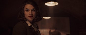 Movie still from “Captain America: The First Avenger” (2011), directed by Joe Johnston – A woman in a suit standing in front of a wall; Close Up shot, Over the shoulder angle