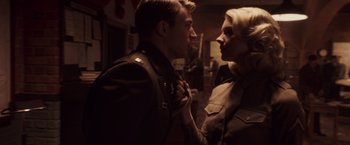 Movie still from “Captain America: The First Avenger” (2011), directed by Joe Johnston – A man and a woman in military uniforms touching foreheads; Medium shot, Low angle