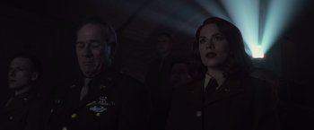 Movie still from “Captain America: The First Avenger” (2011), directed by Joe Johnston – A man and a woman in military uniforms in a dark room; Close Up shot, Low angle