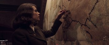 Movie still from “Captain America: The First Avenger” (2011), directed by Joe Johnston – A woman in a military uniform pointing to a map; Close Up shot, High angle