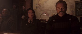 Movie still from “Captain America: The First Avenger” (2011), directed by Joe Johnston – A man and a woman sitting next to each other in front of a map; Medium shot, Over the shoulder angle