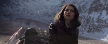 Movie still from “Captain America: The First Avenger” (2011), directed by Joe Johnston – A woman in a brown leather jacket holding an umbrella; Close Up shot, Over the shoulder angle