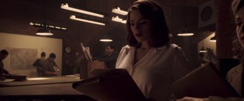 Movie still from “Captain America: The First Avenger” (2011), directed by Joe Johnston – A woman is reading a book in a dark room; Medium shot, Low angle