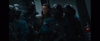 Movie still from “Captain America: The First Avenger” (2011), directed by Joe Johnston – A group of men standing next to each other holding guns; Medium shot, Over the shoulder angle