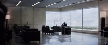 Movie still from “Captain America: The Winter Soldier” (2014), directed by Anthony Russo – A man sitting at a computer desk in front of a large window; Extreme Wide shot, High angle