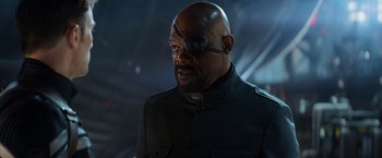 Movie still from “Captain America: The Winter Soldier” (2014), directed by Anthony Russo – A man wearing a uniform and a eye patch; Close Up shot, Over the shoulder angle