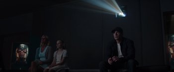 Movie still from “Captain America: The Winter Soldier” (2014), directed by Anthony Russo – A man and a girl sitting in a dark room; Medium shot, Low angle