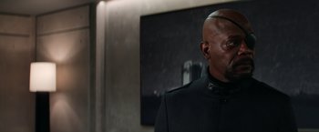 Movie still from “Captain America: The Winter Soldier” (2014), directed by Anthony Russo – A man in a black suit standing in front of a painting; Close Up shot, Over the shoulder angle