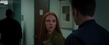 Movie still from “Captain America: The Winter Soldier” (2014), directed by Anthony Russo – A woman with red hair looking at a man in a green jacket; Close Up shot, Over the shoulder angle