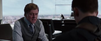 Movie still from “Captain America: The Winter Soldier” (2014), directed by Anthony Russo – An older man sitting in a chair in front of a window; Close Up shot, Over the shoulder angle