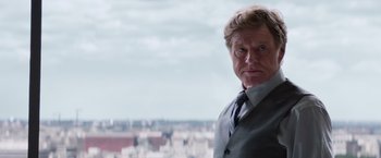 Movie still from “Captain America: The Winter Soldier” (2014), directed by Anthony Russo – A person wearing a suit and tie; Close Up shot, Over the shoulder angle