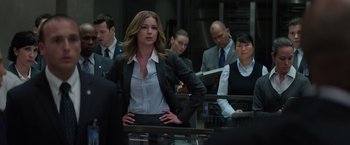 Movie still from “Captain America: The Winter Soldier” (2014), directed by Anthony Russo – A woman standing in front of a group of people; Medium shot, Low angle