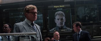 Movie still from “Captain America: The Winter Soldier” (2014), directed by Anthony Russo – A man standing next to another man in front of a screen; Close Up shot, Over the shoulder angle