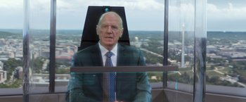 Movie still from “Captain America: The Winter Soldier” (2014), directed by Anthony Russo – A man in a suit and tie sitting in a chair; Close Up shot, Over the shoulder angle