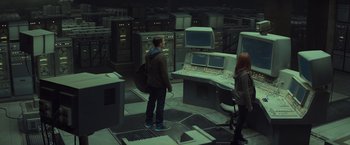 Movie still from “Captain America: The Winter Soldier” (2014), directed by Anthony Russo – A man and a woman standing next to a computer terminal; Wide shot, High angle