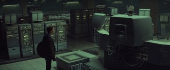 Movie still from “Captain America: The Winter Soldier” (2014), directed by Anthony Russo – A man standing in a room full of computer equipment; Extreme Wide shot, High angle