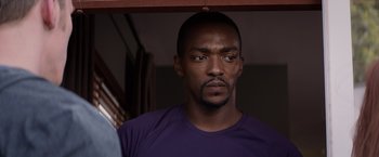 Movie still from “Captain America: The Winter Soldier” (2014), directed by Anthony Russo – A person wearing a purple t - shirt; Close Up shot, Over the shoulder angle
