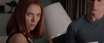 Movie still from “Captain America: The Winter Soldier” (2014), directed by Anthony Russo – A woman's face with a lamp in the background; Close Up shot, Over the shoulder angle